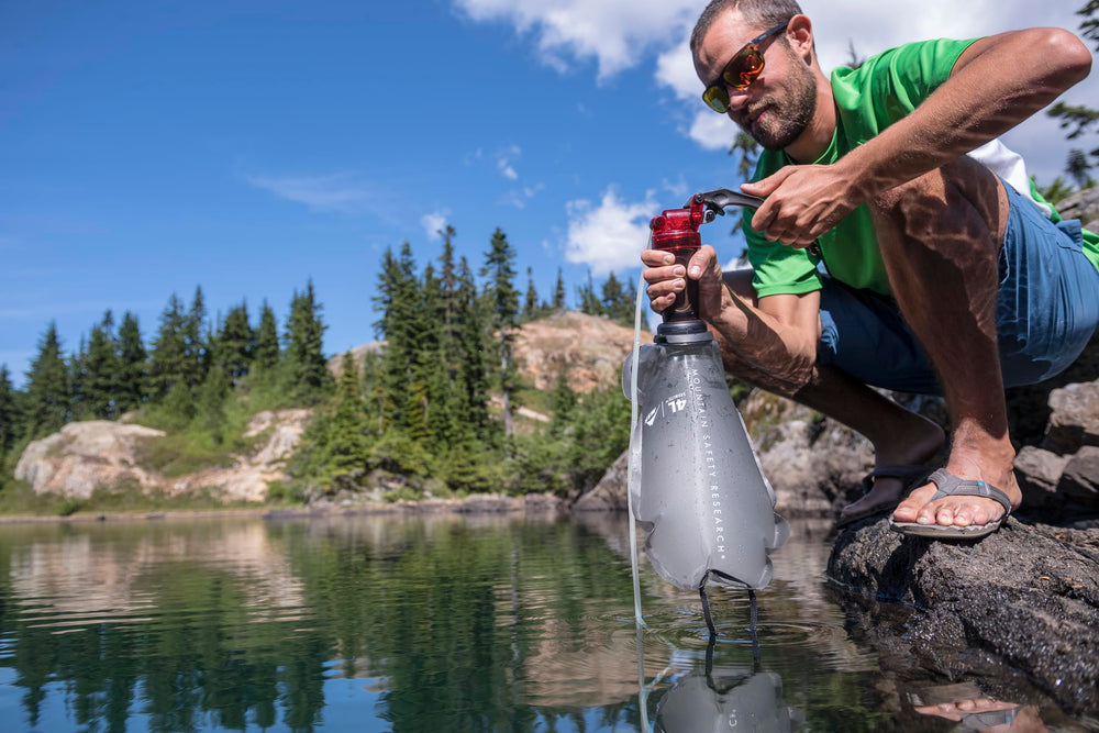 MSR MiniWorks pump in use at campsite showing fast liter-per-minute pumping convenience