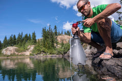 MSR MiniWorks pump in use at campsite showing fast liter-per-minute pumping convenience