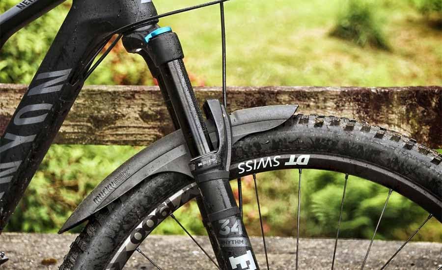 Mucky Nutz MugGuard mounted on suspension fork protecting seals and stanchions