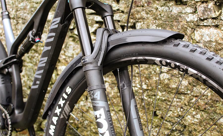 Mucky Nutz guard beside wheel showing compatibility with 26 to 29 inch sizes
