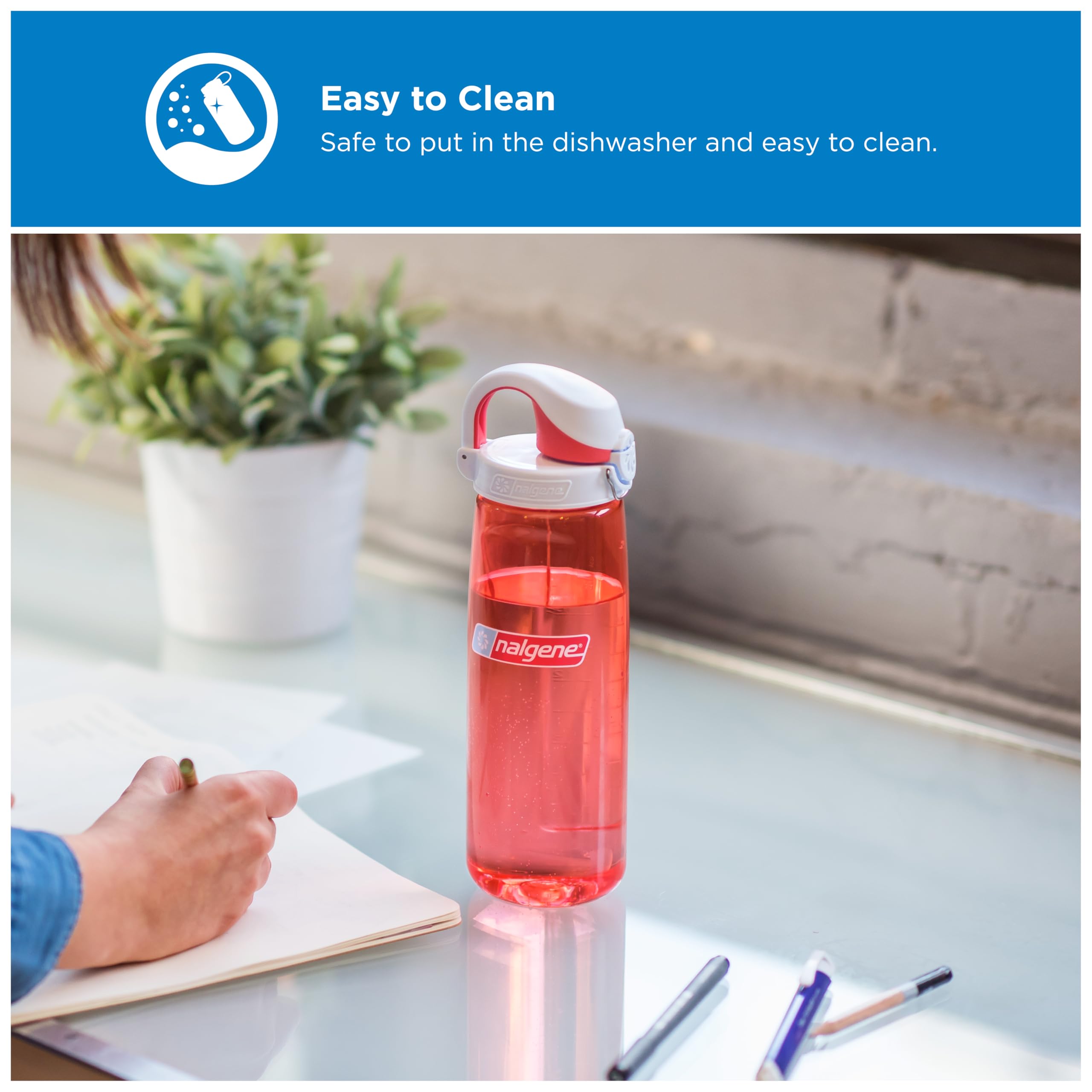 Nalgene bottle in car cupholder showing coral bottle fits standard holders for travel