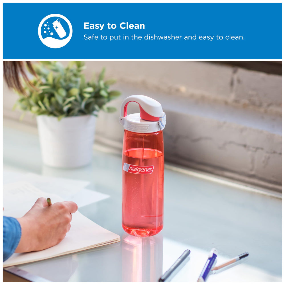 Nalgene bottle in car cupholder showing coral bottle fits standard holders for travel