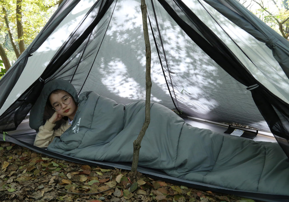 Nature Link sleeping bag in use at campsite demonstrating warmth and outdoor utility