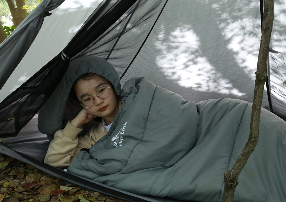 Nature Link sleeping bag next to water bottle showing length and scale for tall users