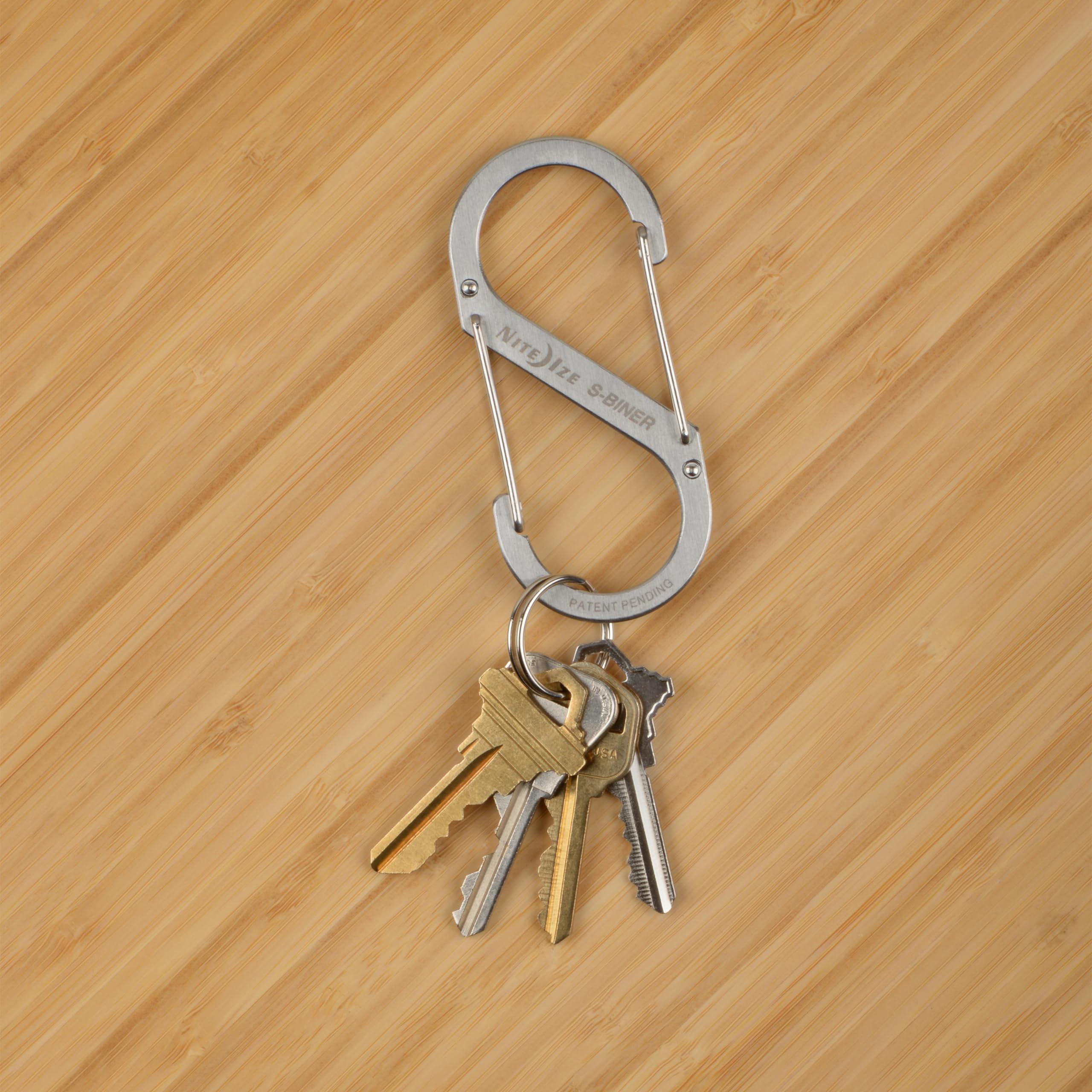 Nite Ize clip fastened to backpack strap showing reliable gear attachment on trail