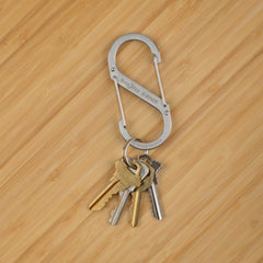 Nite Ize clip fastened to backpack strap showing reliable gear attachment on trail