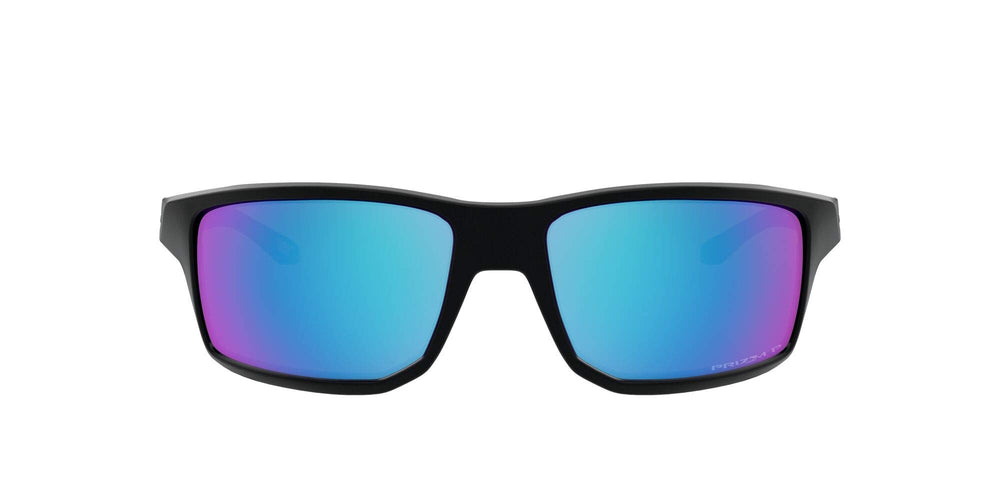 Oakley Gibston front view showing matte black frame and PRIZM Sapphire lens benefit clarity
