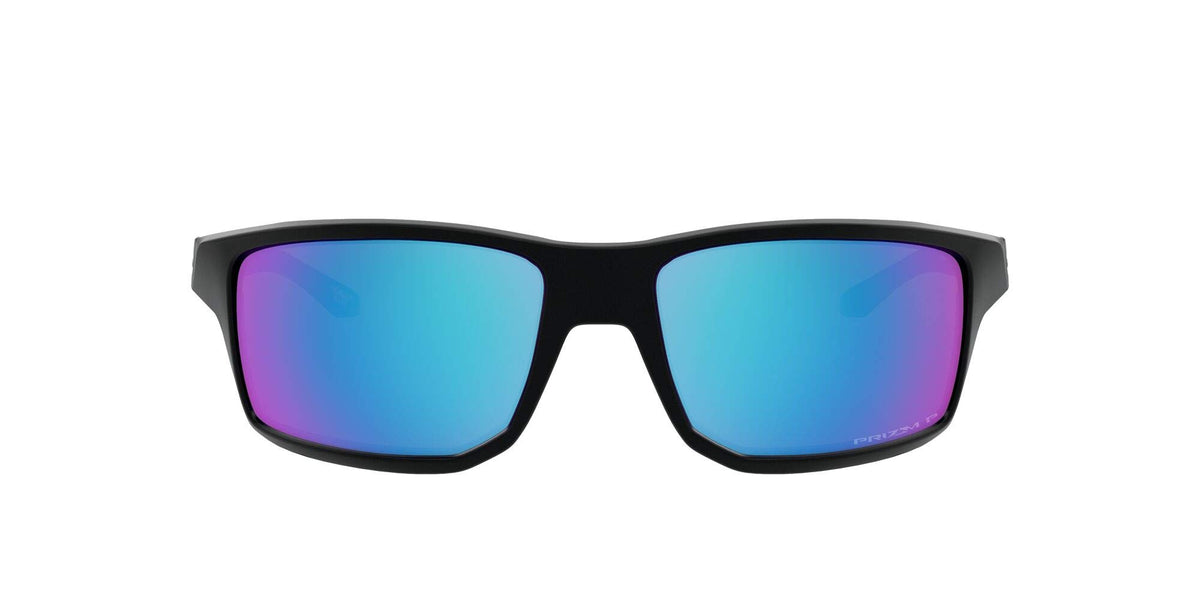 Oakley Gibston front view showing matte black frame and PRIZM Sapphire lens benefit clarity
