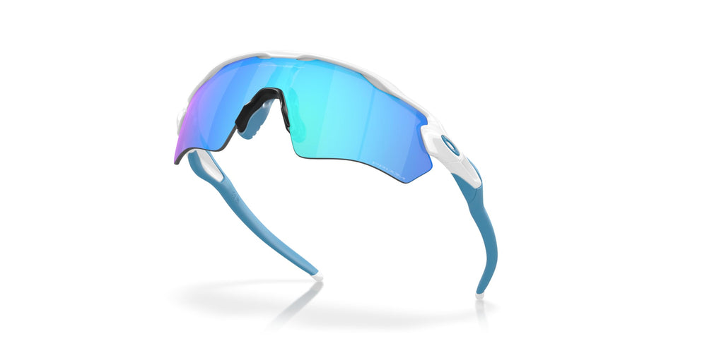Oakley sunglasses next to child-sized ruler indicating scaled-for-juniors fit