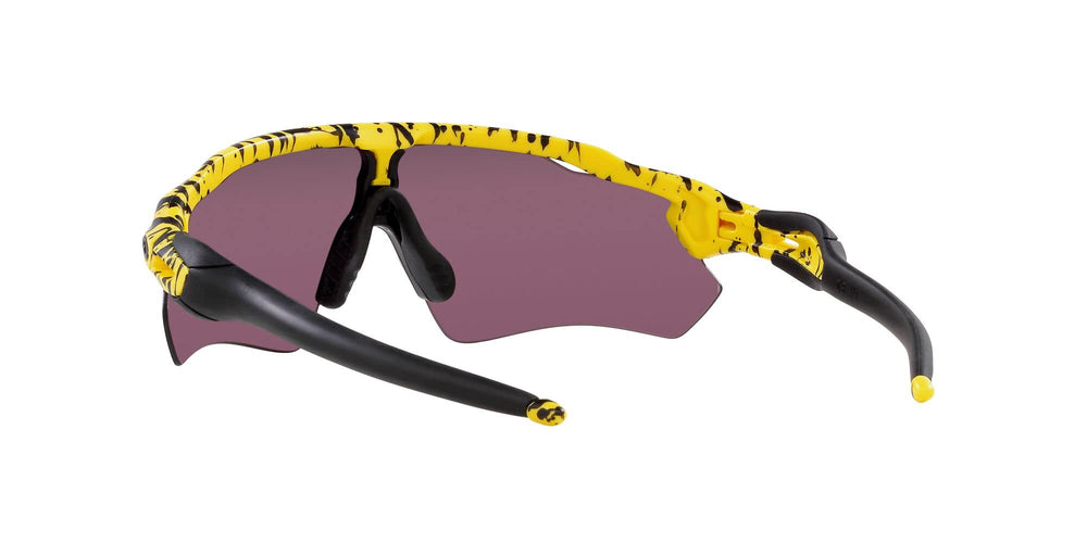 Oakley sunglasses next to bike helmet showing scale and cycling readiness