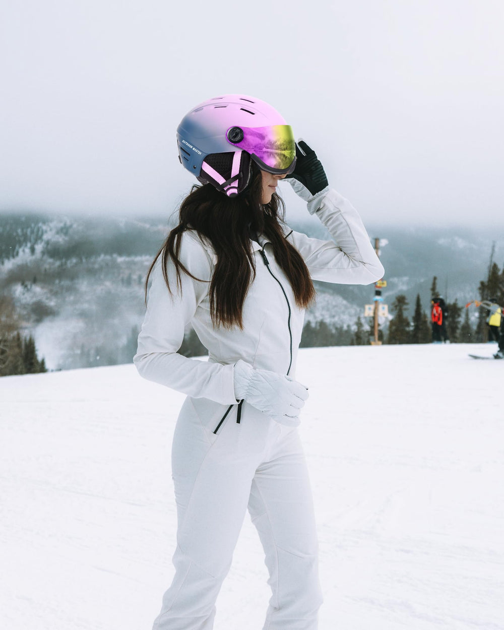 OutdoorMaster helmet worn on mountain by skier showing integrated visor for wind protection