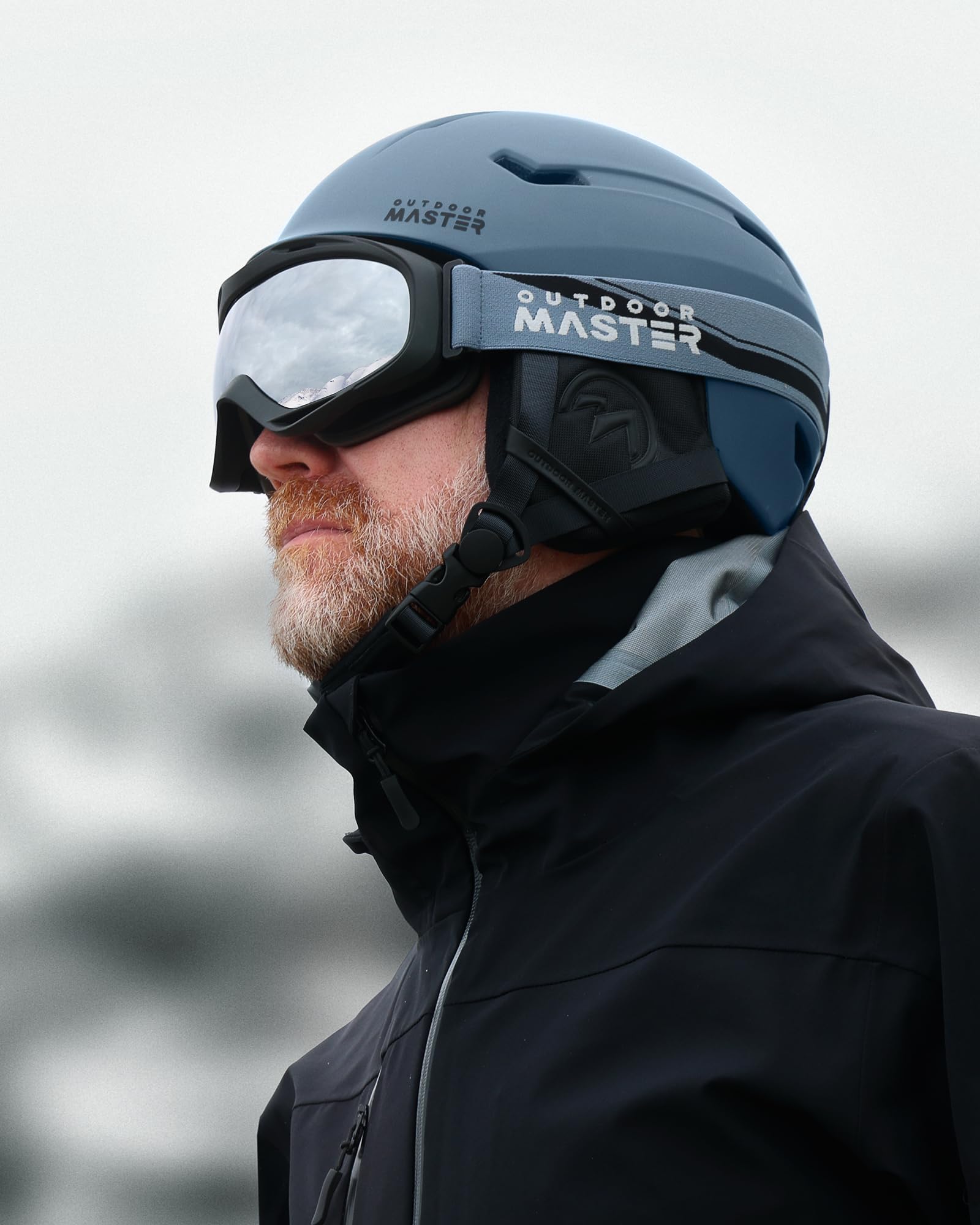 OutdoorMaster helmet and goggles set in use on a snowy slope portraying real-world protection