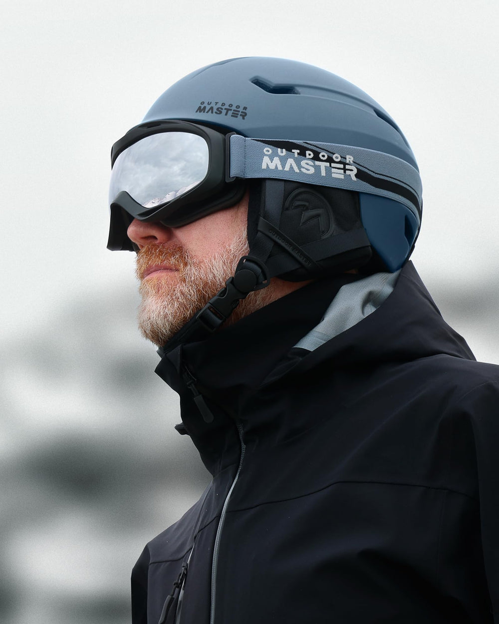 OutdoorMaster helmet and goggles set in use on a snowy slope portraying real-world protection