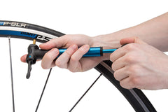 Park Tool PMP-3.2B in hand pumping tire, fast roadside inflation benefit