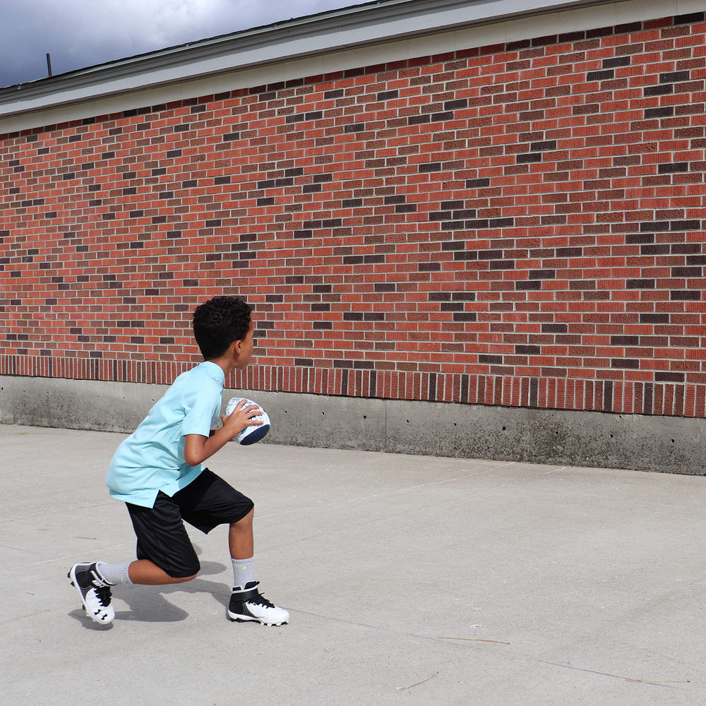 Passback Peewee in backyard with child practicing catches for skill building