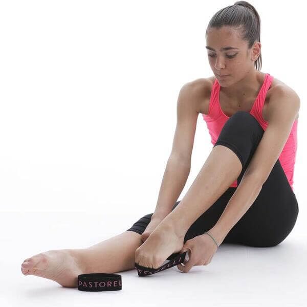 Pastorelli band on foot next to ruler for scale, clarifying fit and sizing benefits