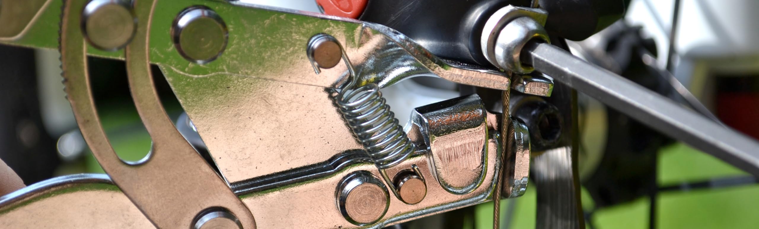 Pedro's cable puller in use on a bicycle holding cable tension for precise pinch-bolt tightening