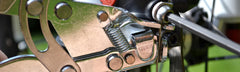 Pedro's cable puller in use on a bicycle holding cable tension for precise pinch-bolt tightening
