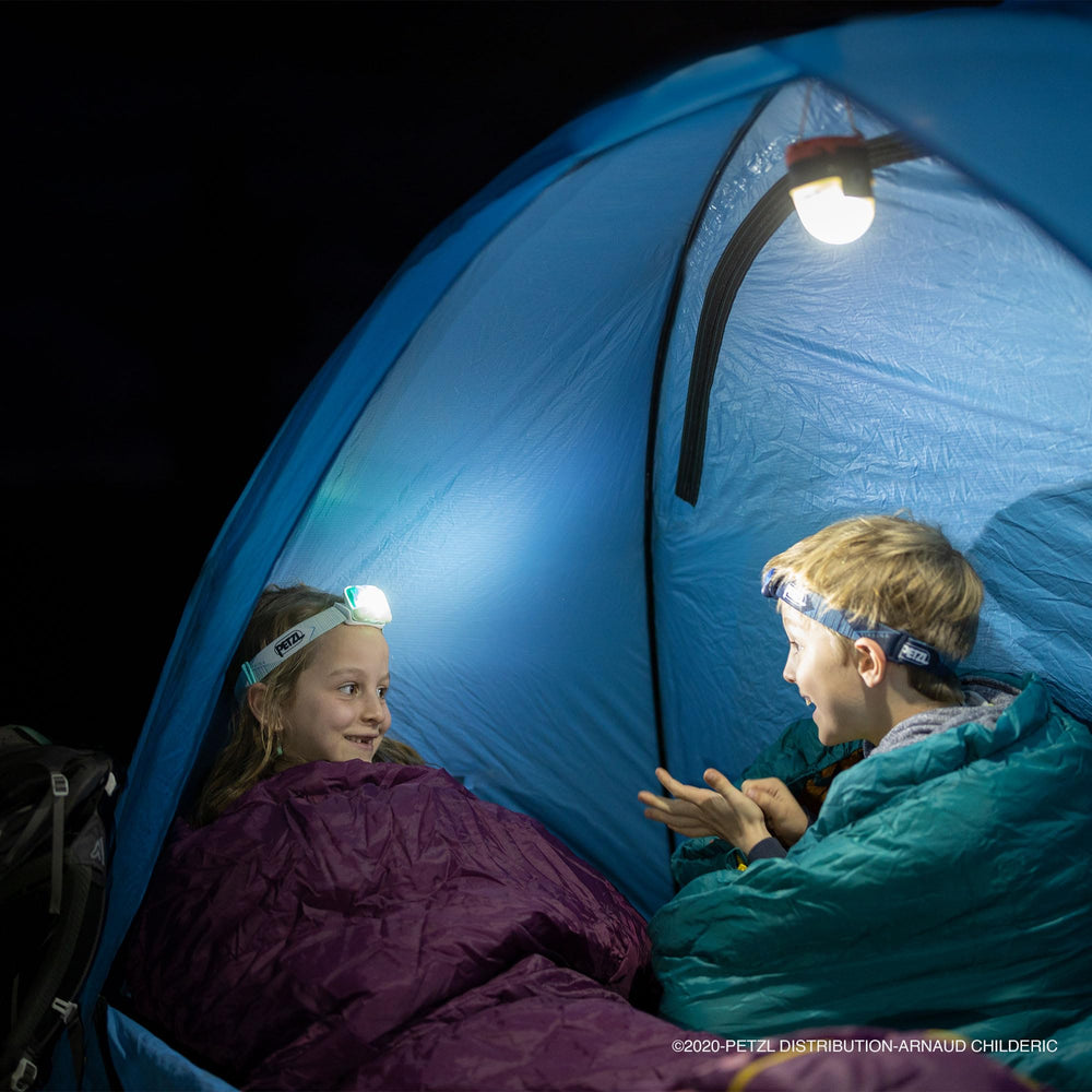 Petzl NOCTILIGHT on a camp table illustrating practical campsite ambient lighting