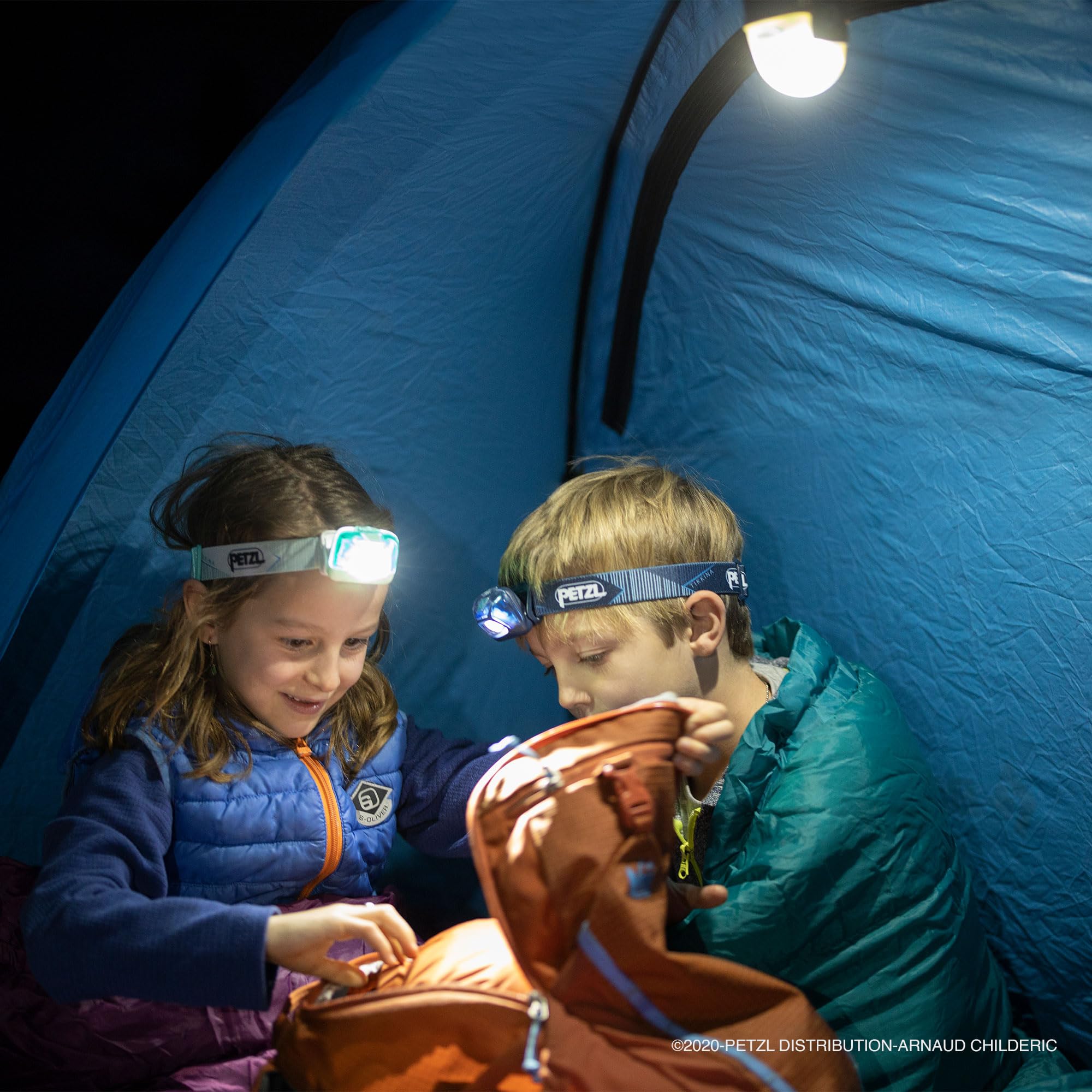 Petzl NOCTILIGHT beside a headlamp for size comparison and easy packing benefit