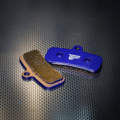 PIVOTRAX pads beside a ruler for size comparison and easy installation