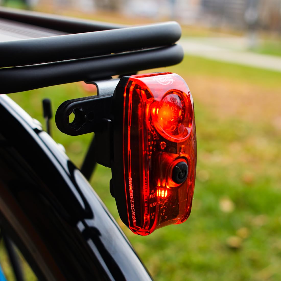 Planet Bike Superflash 65 open battery compartment showing easy AAA battery replacement