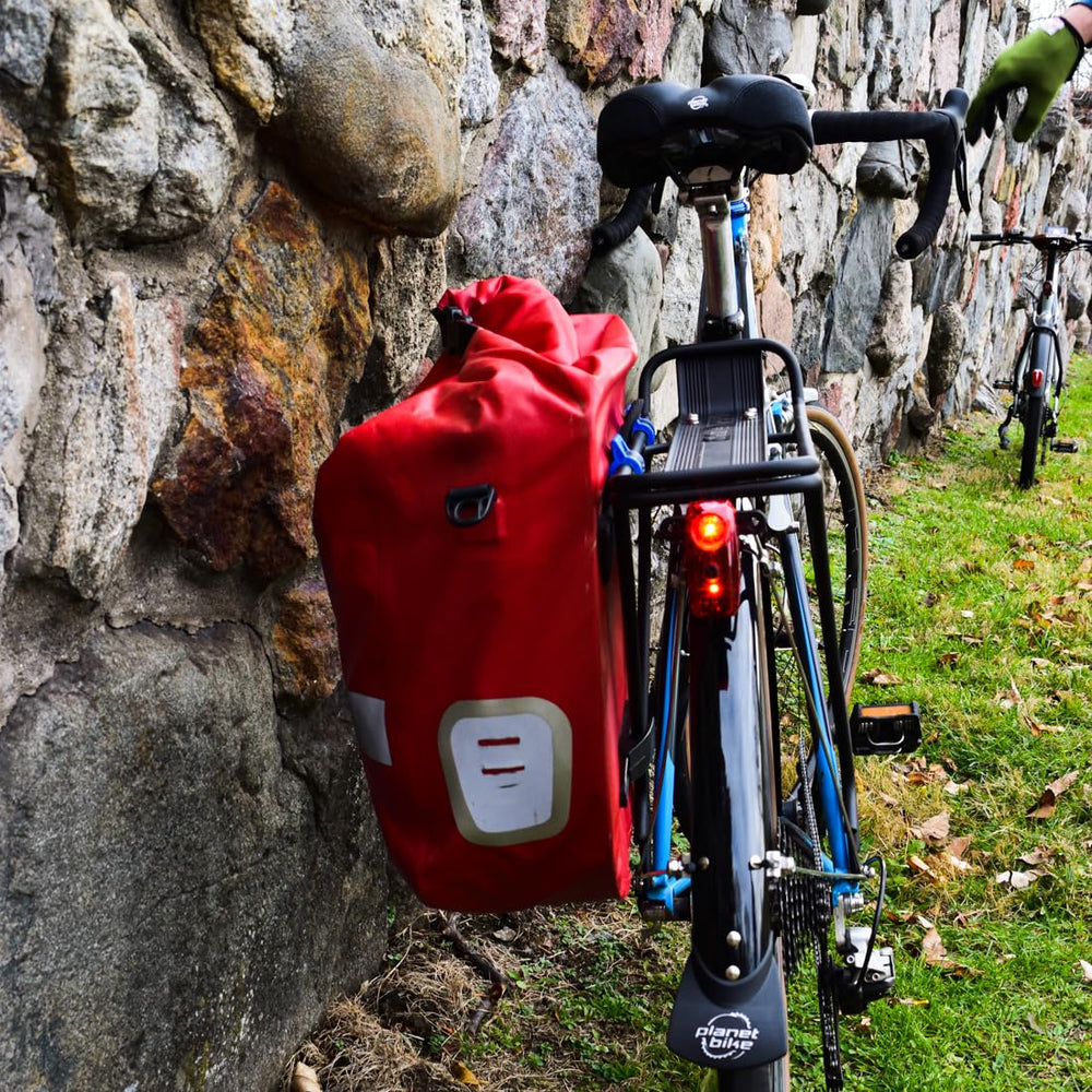 Planet Bike Superflash 65 clipped to backpack showing portable use and commuter safety
