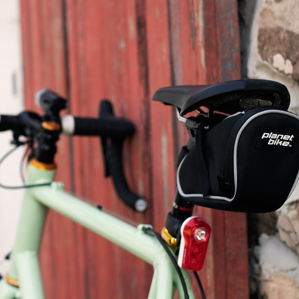 Planet Bike Superflash with batteries beside it showing easy battery replacement