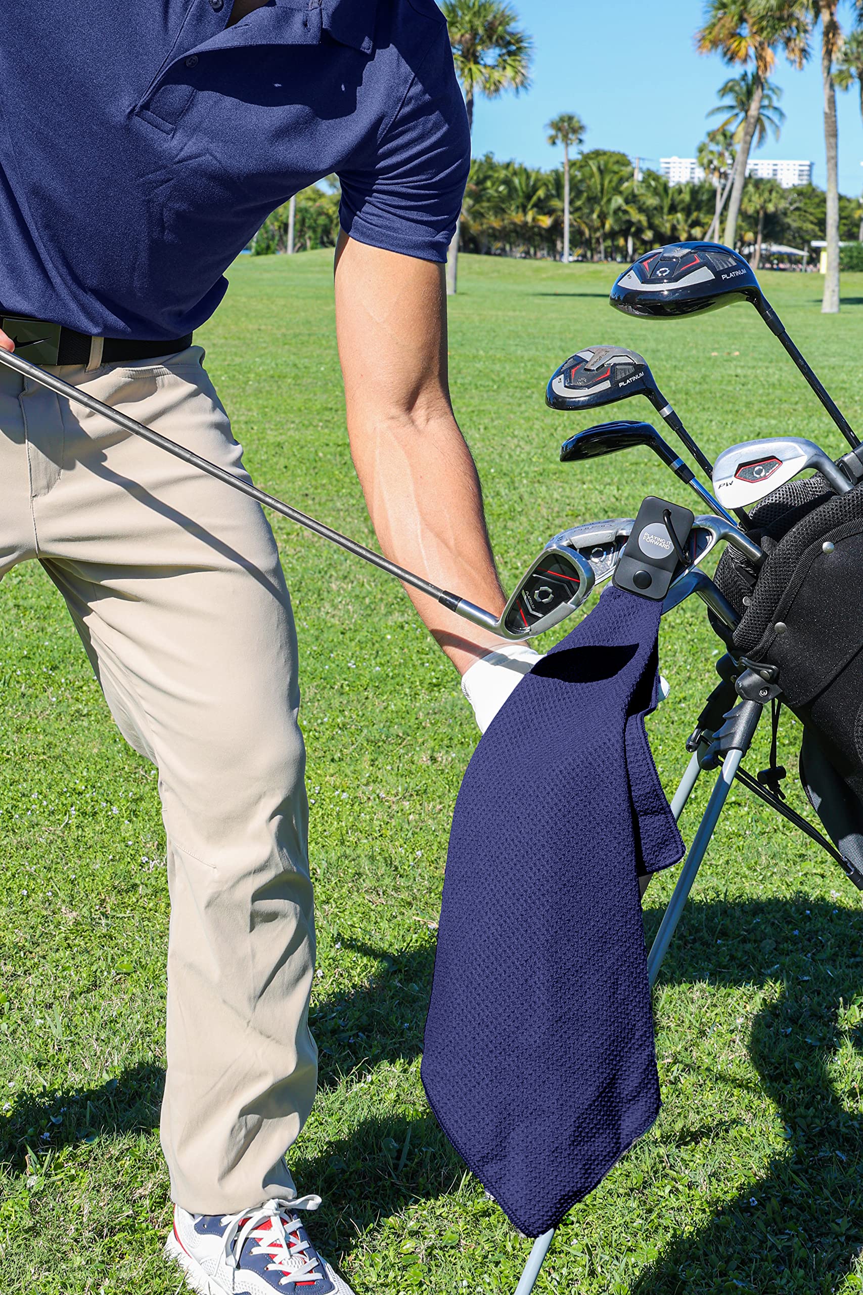 Playing It Forward folded towel beside a glove showing compact storage and travel benefit