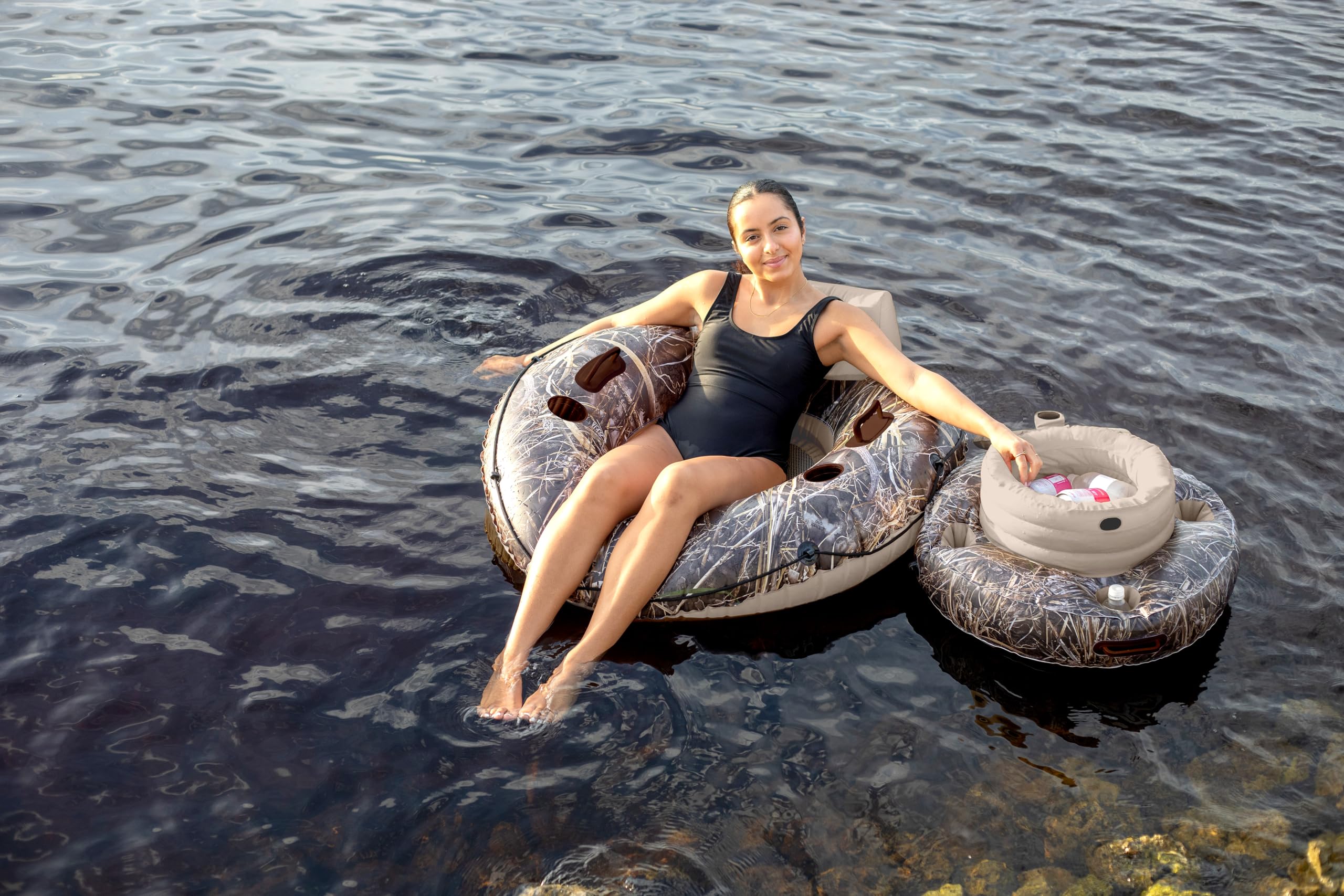 PoolCandy Realtree Max-7 floating in a pool next to loungers for convenient on-water refreshment