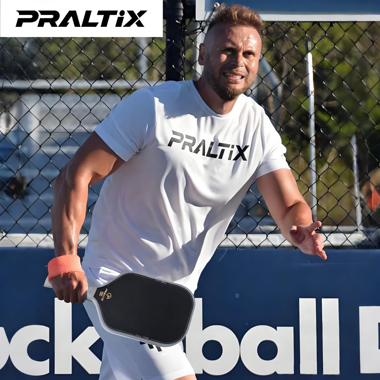 Praltix T700 beside a hand for scale showing lightweight 7.7–8.0oz balance for fast swings
