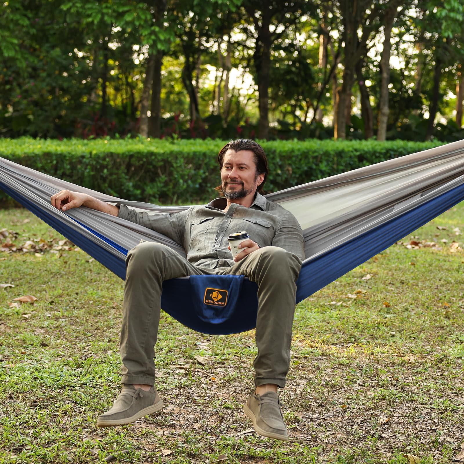 Qevooon hammock beside backpack showing compact travel-friendly size benefit