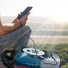 Qoolife built-in Bluetooth speaker panel visible delivering wireless audio outdoors