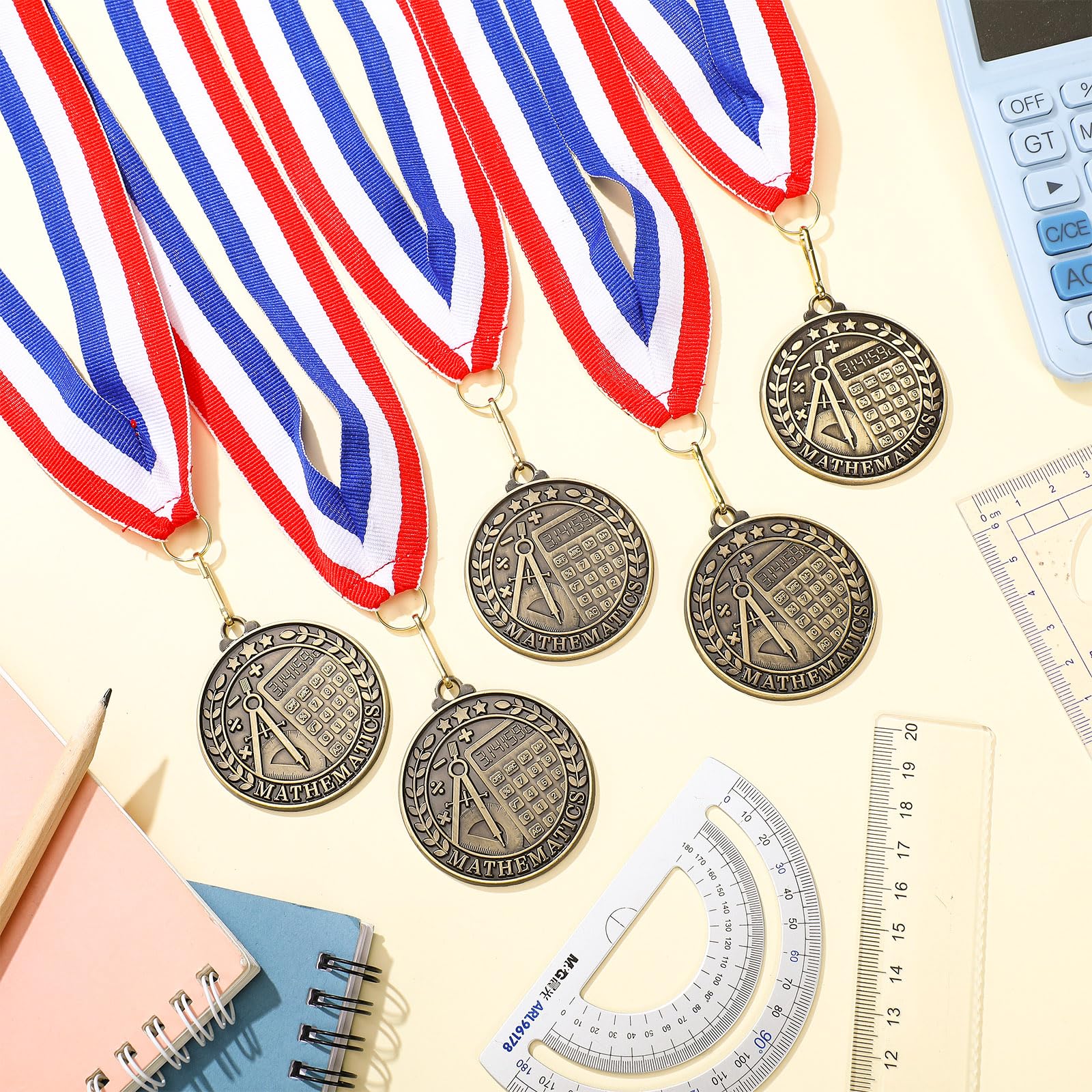 Quelay group of multiple medals laid out showing ample quantity for events
