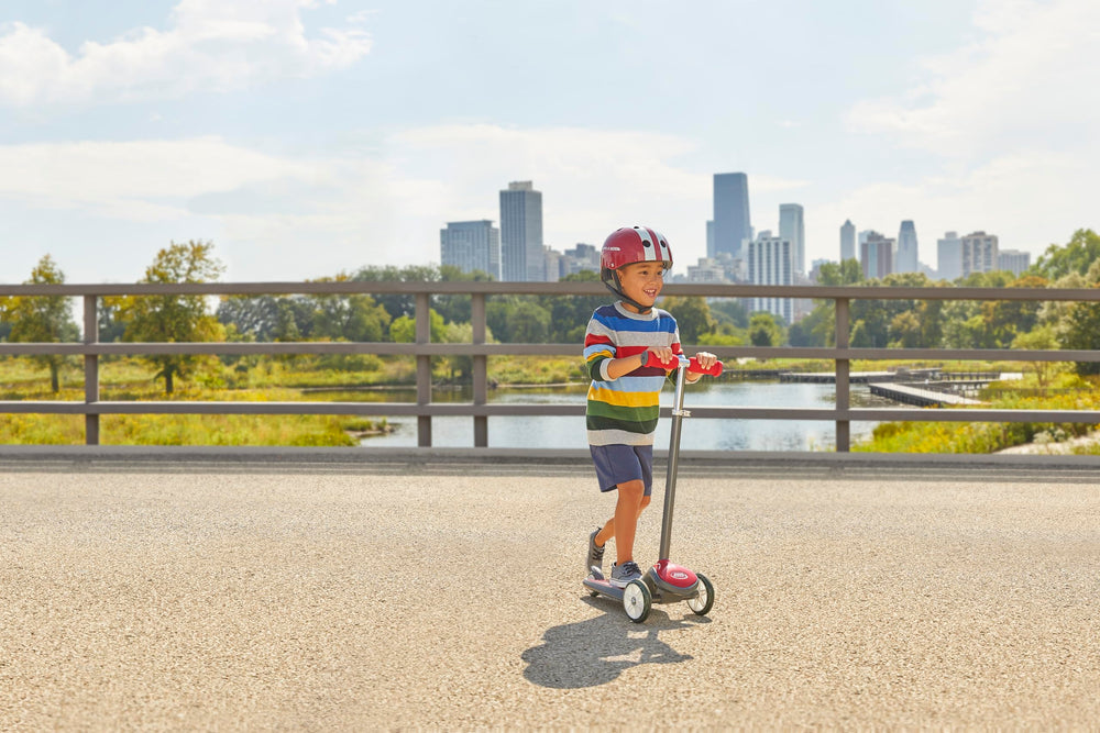 Radio Flyer pink helmet size comparison beside toys illustrating fit for ages 2 to 5
