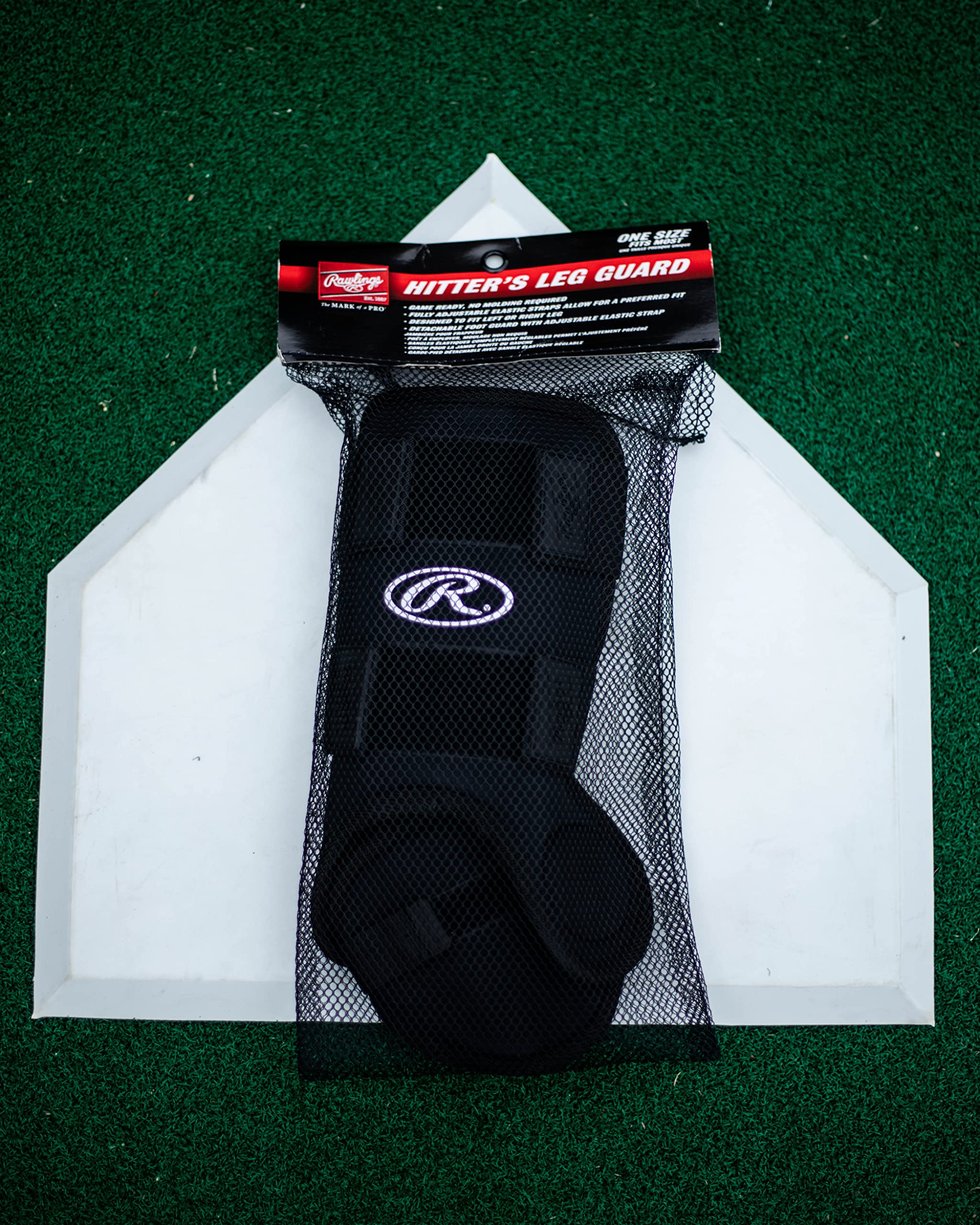 Rawlings leg guard beside bat for scale showing adult size fit