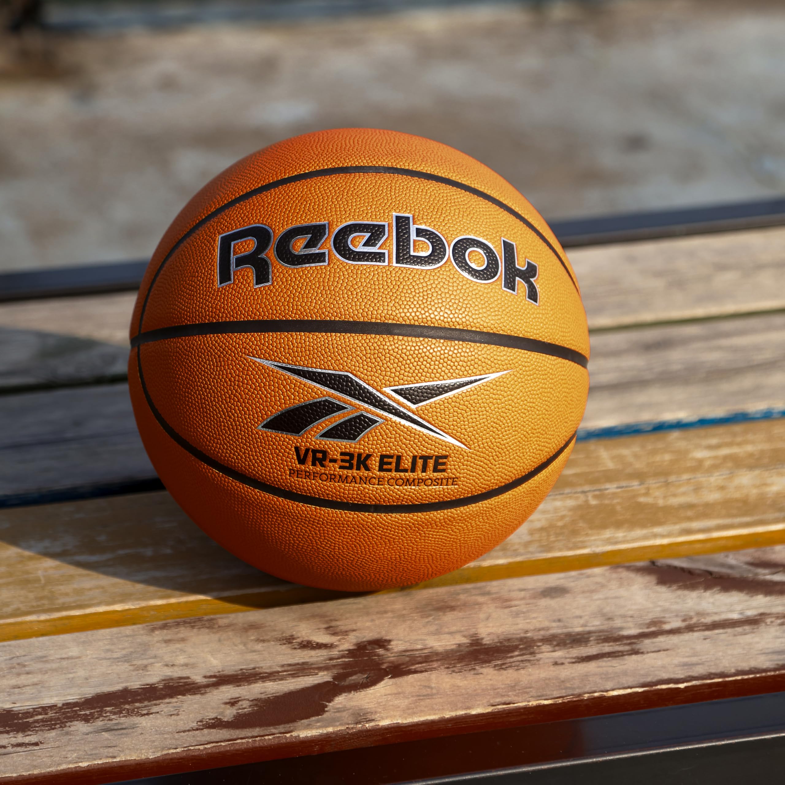 Reebok ball on outdoor court showing hi-vis color for easier tracking during play