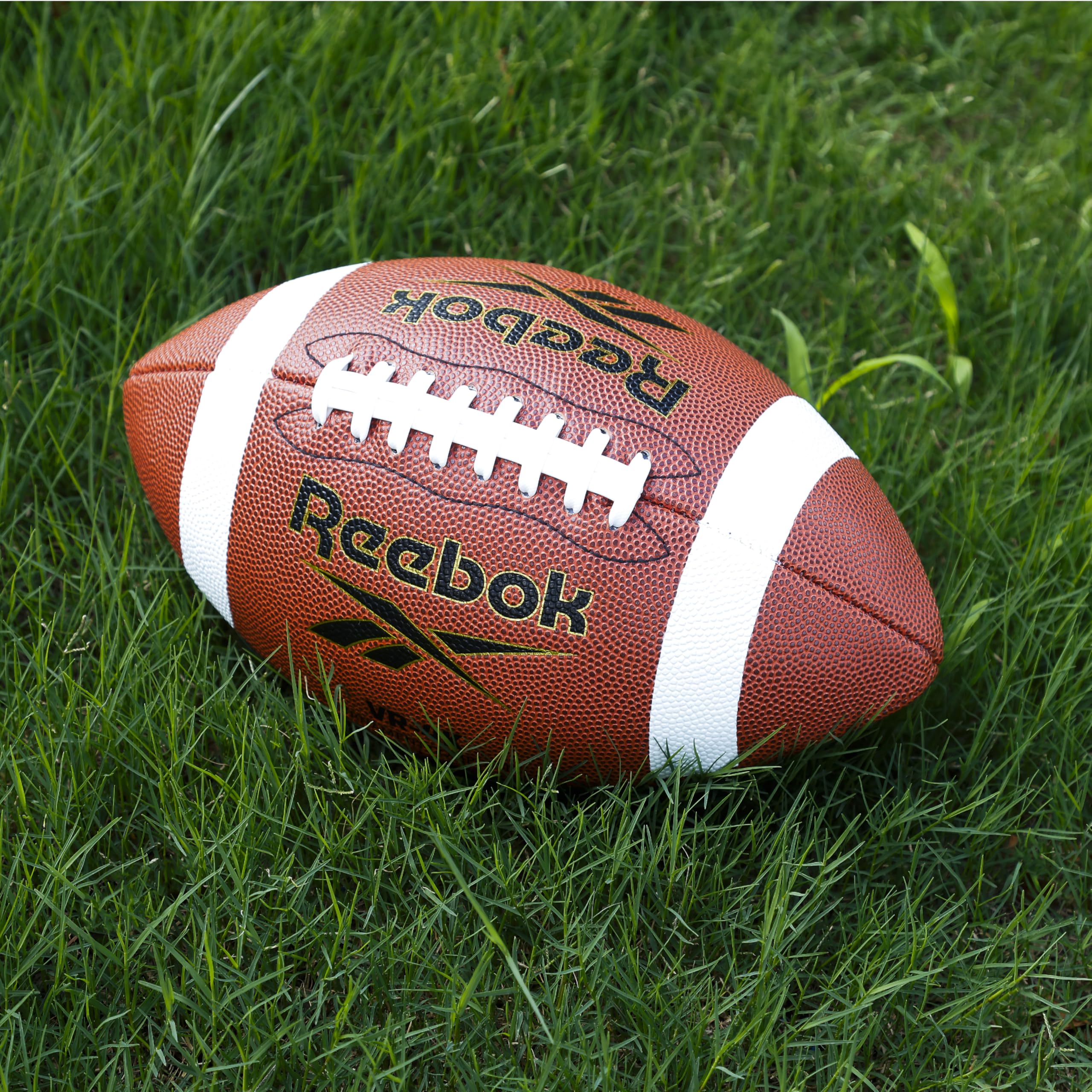 Reebok ball on grass showing reinforced lining durability after impact