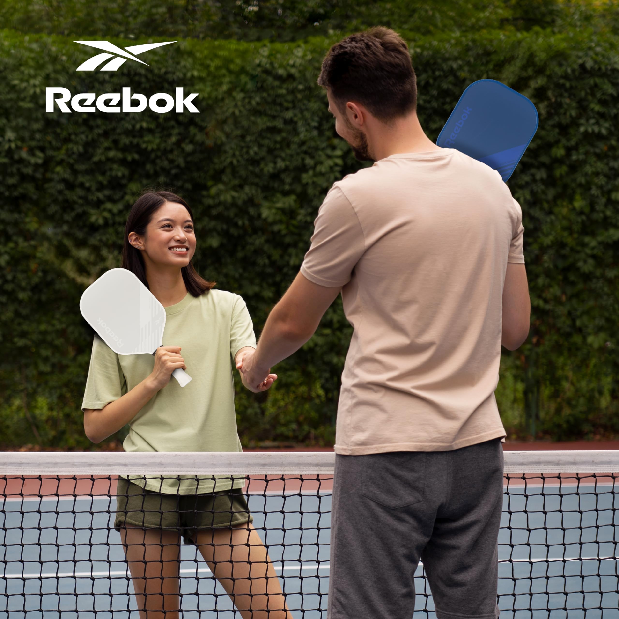 Reebok paddles in use at the net showing on-court performance and control benefits