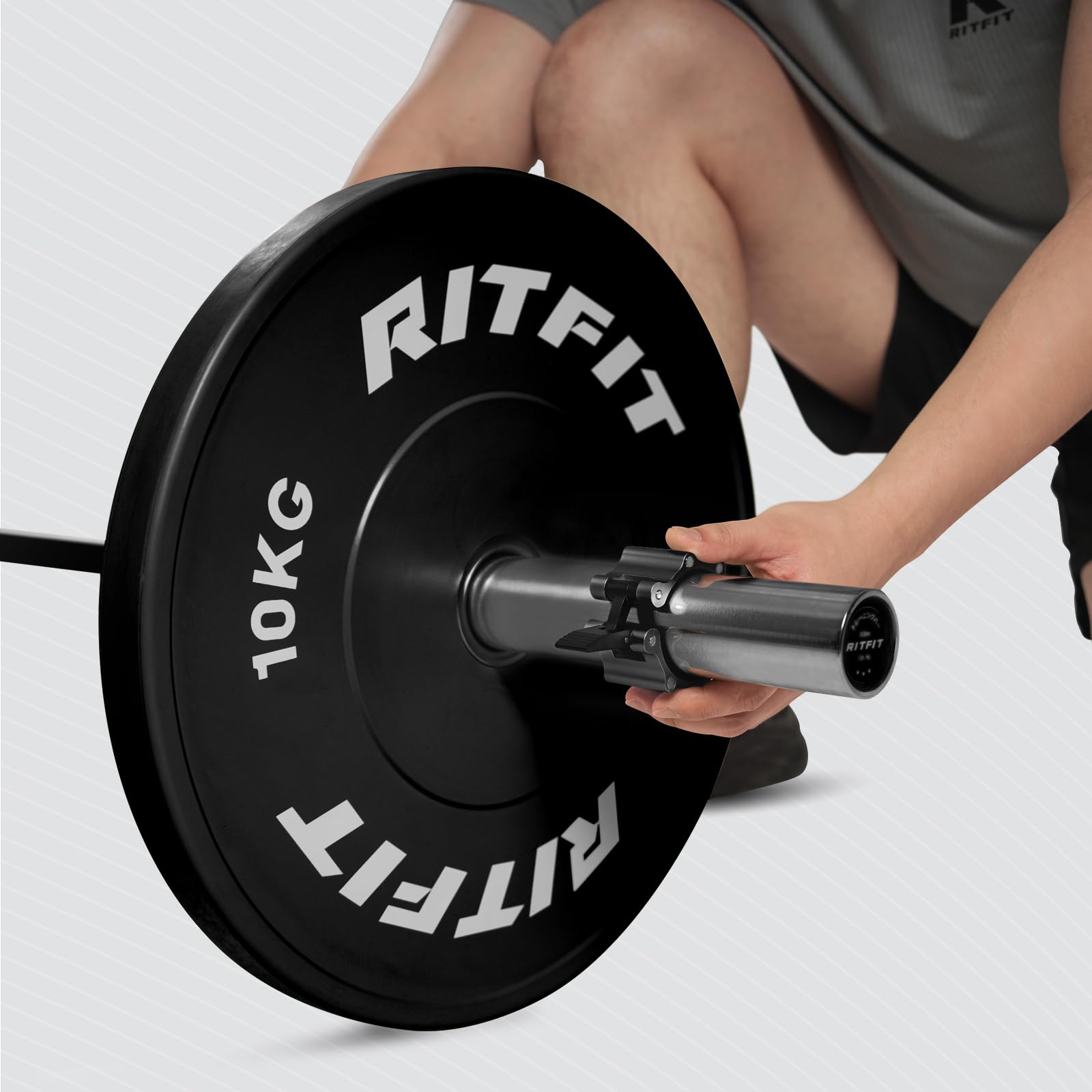 RitFit pair held in lifter's hand showing one-handed quick-release convenience