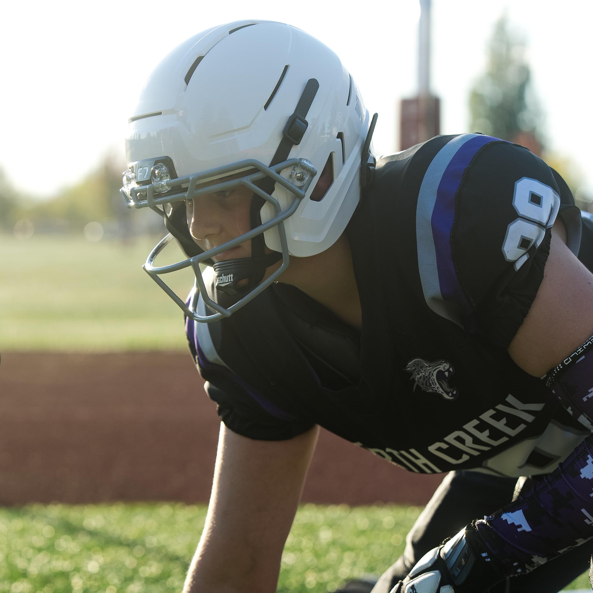 Schutt F7 AiR Youth beside a ruler for clear size and weight reference