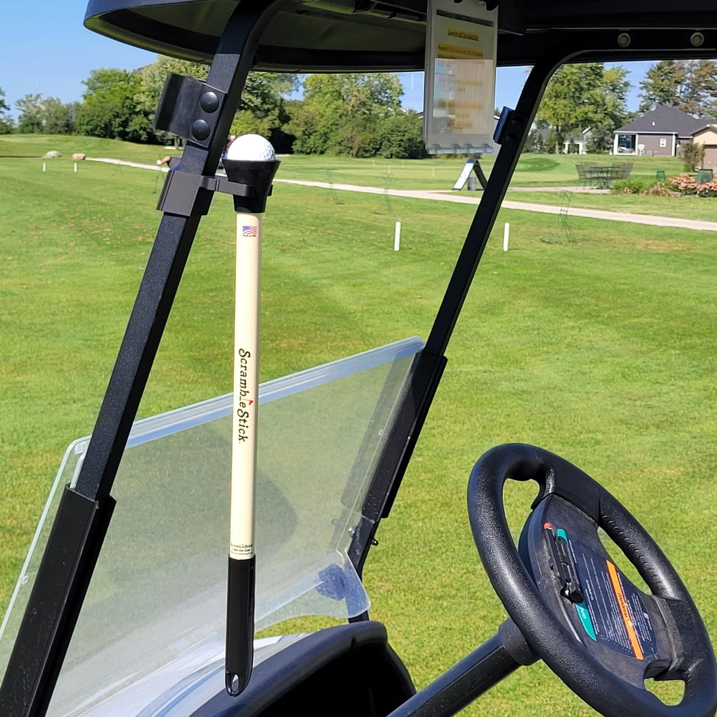 ScrambleClip mounted on a golf cart console for organized gear storage