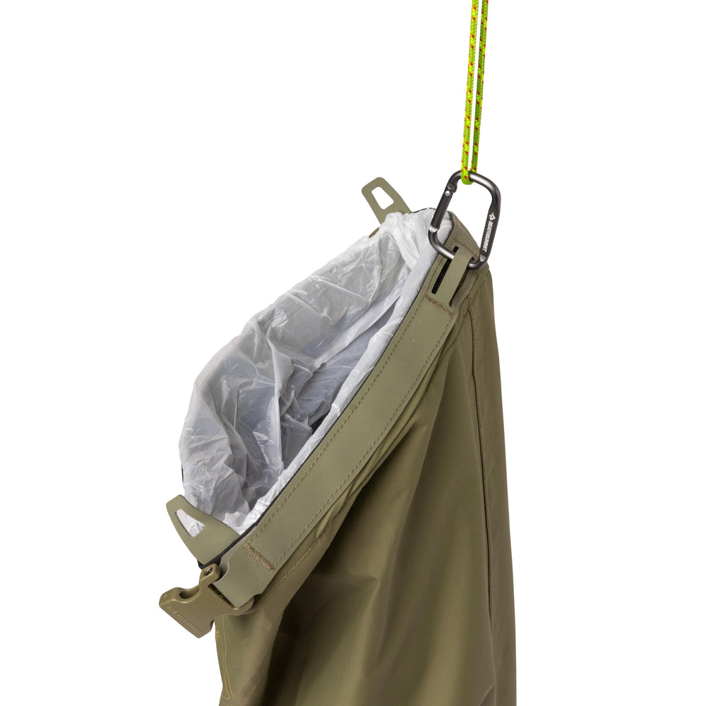Sea to Summit trash dry bag clipped to backpack daisy chain illustrating secure attachment and space-saving