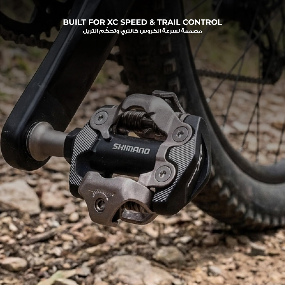 SHIMANO PD-M8100 mounted on bike during gravel ride illustrating low-profile stance and confident clipping in varied terrain