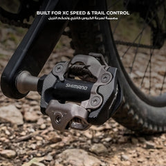 SHIMANO PD-M8100 mounted on bike during gravel ride illustrating low-profile stance and confident clipping in varied terrain