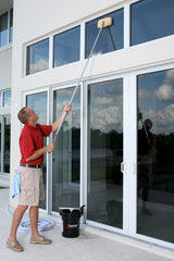 Shurhold combo attached to handle in use cleaning boat window with extended reach
