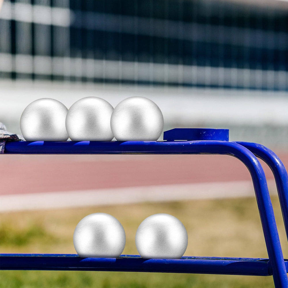 Silipull shot put resting on track surface illustrating outdoor use and practice readiness