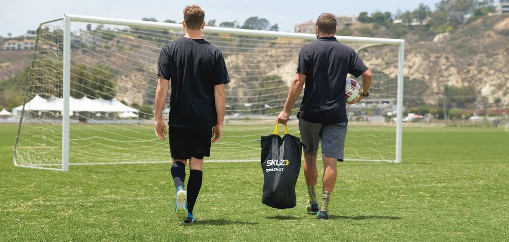 SKLZ Goalshot beside soccer ball showing scale and regulation 24x8 fit