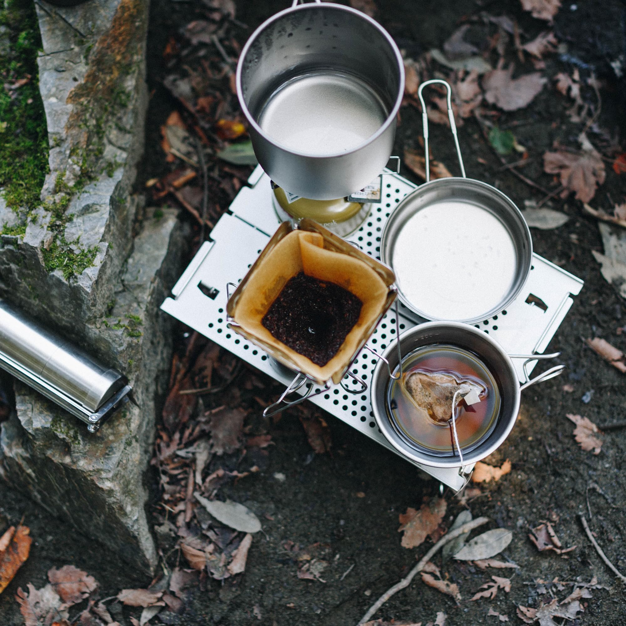 Snow Peak Ozen Solo Table on campsite with gear showing functional minimalist design benefit