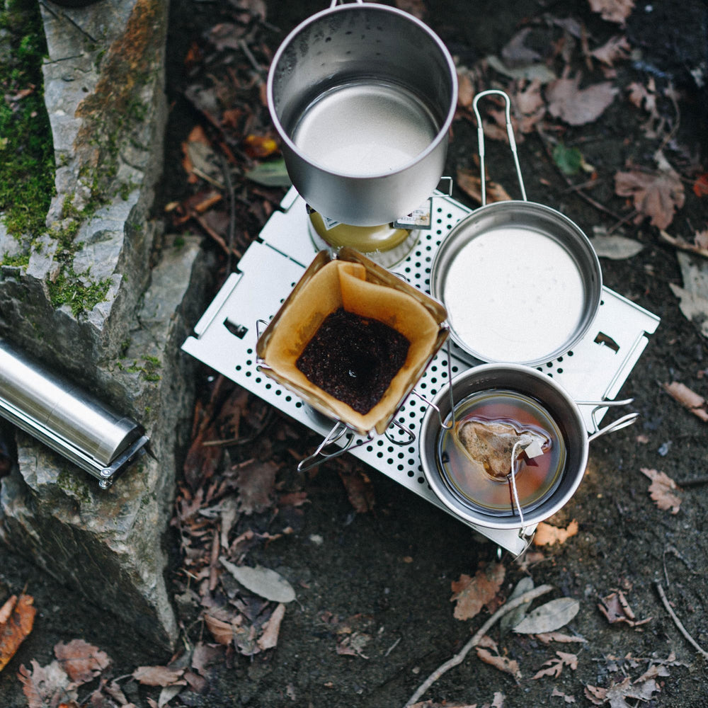 Snow Peak Ozen Solo Table on campsite with gear showing functional minimalist design benefit